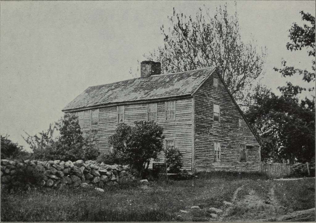 Old house in New England with a stone wall.